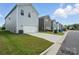 Modern home exterior with a two-car garage, lawn, and a neat driveway at 125 Cedar Knoll Cir, Pineville, NC 28134
