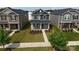 Aerial view of two-story home with stone facade, landscaping, and sidewalk at 125 Cedar Knoll Cir, Pineville, NC 28134
