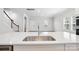 Bright kitchen showcases a sink in the island with stainless appliances and white cabinets at 125 Cedar Knoll Cir, Pineville, NC 28134