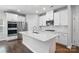 Bright kitchen features white cabinets, quartz countertops, stainless steel appliances, and an island at 125 Cedar Knoll Cir, Pineville, NC 28134