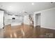 Open-concept living space with hardwood floors, seamlessly connecting living, dining, and kitchen areas at 125 Cedar Knoll Cir, Pineville, NC 28134