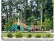 Community playground with green slides, climbing areas, and seating amid lush greenery at 125 Cedar Knoll Cir, Pineville, NC 28134