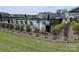Community pool area featuring black metal fencing, lounge chairs and manicured landscaping at 125 Cedar Knoll Cir, Pineville, NC 28134