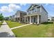 A neighborhood street featuring well-manicured lawns and attractive two-story homes on a sunny day at 125 Cedar Knoll Cir, Pineville, NC 28134