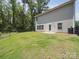 A spacious backyard with a patio, lawn, and a black metal fence at 125 Fosters Glen Pl, Mooresville, NC 28115