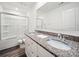 Bathroom with a double sink vanity, granite countertop, and a shower with sliding glass doors at 125 Fosters Glen Pl, Mooresville, NC 28115