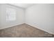 Bright bedroom with a window and neutral carpet at 125 Fosters Glen Pl, Mooresville, NC 28115