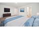 Bright bedroom features a TV, blue accents, and white walls, creating a serene and inviting space at 125 Fosters Glen Pl, Mooresville, NC 28115