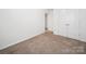 Bedroom featuring a closet with double doors and neutral carpet at 125 Fosters Glen Pl, Mooresville, NC 28115
