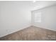 Bright bedroom with neutral carpet, a window and white walls create a blank canvas for comfortable living at 125 Fosters Glen Pl, Mooresville, NC 28115