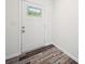 Bright entryway featuring a white door with a window and stylish laminate flooring at 125 Fosters Glen Pl, Mooresville, NC 28115