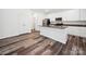 A spacious kitchen features white cabinets, granite countertops, stainless steel appliances and wood-look flooring at 125 Fosters Glen Pl, Mooresville, NC 28115