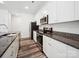 Bright kitchen features white cabinets, granite counters, stainless steel appliances and stylish wood-look floors at 125 Fosters Glen Pl, Mooresville, NC 28115