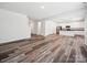 Spacious open-concept living space featuring wood-look floors, white walls, and lots of natural light at 125 Fosters Glen Pl, Mooresville, NC 28115