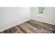 Bright, empty room featuring laminate wood flooring and white walls at 125 Fosters Glen Pl, Mooresville, NC 28115
