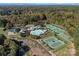 Beautiful aerial view of community with tennis courts, pool, playground, and clubhouse surrounded by colorful autumn foliage at 131 Cherry Bark Dr, Mooresville, NC 28117