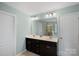 Bright bathroom with dual sinks, a large mirror, and stylish vanity lighting at 131 Cherry Bark Dr, Mooresville, NC 28117
