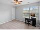 Bedroom featuring a ceiling fan, large window, and desk area at 131 Cherry Bark Dr, Mooresville, NC 28117