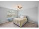 Cozy bedroom with a large window, ceiling fan and comfortable furnishings at 131 Cherry Bark Dr, Mooresville, NC 28117