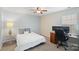 Spacious bedroom featuring a ceiling fan, carpet flooring, and adjacent desk area at 131 Cherry Bark Dr, Mooresville, NC 28117