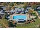 Aerial view of a community pool surrounded by seating, landscaping, and recreational facilities at 131 Cherry Bark Dr, Mooresville, NC 28117