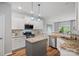 Bright kitchen featuring white cabinets, granite countertops, and stainless steel appliances at 131 Cherry Bark Dr, Mooresville, NC 28117