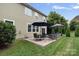 Back patio featuring a dining table, seating area, grassy yard, and backyard, creating an inviting outdoor space at 131 Cherry Bark Dr, Mooresville, NC 28117