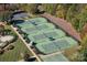 Aerial view of well-maintained tennis courts with lush greenery and landscaping at 131 Cherry Bark Dr, Mooresville, NC 28117