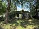 Overgrown exterior shows a dilapidated home with extensive vegetation and signs of neglect at 1317 Moretz Ave, Charlotte, NC 28206