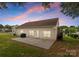 Rear exterior view with a concrete patio, vinyl siding, well-maintained lawn, and mature trees at 133 Fontanelle Dr, Mooresville, NC 28115