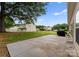 Spacious backyard with a concrete patio, lawn, mature trees, and a grill at 133 Fontanelle Dr, Mooresville, NC 28115