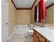 Bathroom featuring neutral walls, a soaking tub, tile flooring, and vanity with sink at 133 Fontanelle Dr, Mooresville, NC 28115