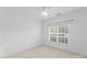 Well-lit bedroom features neutral walls, light carpet, and a large window with blinds at 133 Fontanelle Dr, Mooresville, NC 28115
