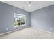 Cozy bedroom features a light blue wall color and a window bringing in ample natural light at 133 Fontanelle Dr, Mooresville, NC 28115
