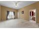 Primary bedroom featuring neutral walls, carpet flooring, and a private bathroom with neutral color palette at 133 Fontanelle Dr, Mooresville, NC 28115