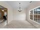 Bright, airy dining room featuring neutral walls, carpet flooring, natural light, and chandelier at 133 Fontanelle Dr, Mooresville, NC 28115