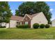 Charming home exterior featuring brick accents, manicured shrubs, and an attached garage at 133 Fontanelle Dr, Mooresville, NC 28115
