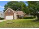 Charming brick home features a well-manicured front yard and attached garage at 133 Fontanelle Dr, Mooresville, NC 28115