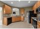 Well-lit kitchen featuring wooden cabinets, modern appliances, and a view into the living area at 133 Fontanelle Dr, Mooresville, NC 28115