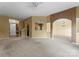 Spacious living area with neutral carpet, arched openings, and a chandelier, creating a warm atmosphere at 133 Fontanelle Dr, Mooresville, NC 28115