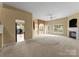 Expansive living room featuring neutral carpet, a ceiling fan, a fireplace, and natural light at 133 Fontanelle Dr, Mooresville, NC 28115