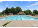 Large community pool with plenty of seating surrounded by lush greenery at 133 Fontanelle Dr, Mooresville, NC 28115