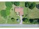 Aerial view of home with brown roof, set in large yard with mature trees and a gray driveway at 157 Blackberry Ln, Taylorsville, NC 28681
