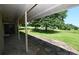 Covered back porch with stone flooring and a beautiful view of the green backyard at 157 Blackberry Ln, Taylorsville, NC 28681