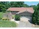 Charming brick home with a two-car garage nestled on a wooded lot and lush green lawn at 157 Blackberry Ln, Taylorsville, NC 28681