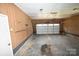 Spacious garage with paneled walls, overhead lighting, and large door perfect for storage at 157 Blackberry Ln, Taylorsville, NC 28681