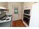 Well-lit kitchen with a view to the backyard, complete with a microwave, oven, and cooktop at 157 Blackberry Ln, Taylorsville, NC 28681
