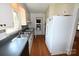 Kitchen featuring stainless steel sink, white cabinets, and black appliances at 157 Blackberry Ln, Taylorsville, NC 28681