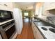 Bright kitchen featuring stainless steel appliances, wooden floors, and ample counter space at 157 Blackberry Ln, Taylorsville, NC 28681