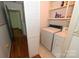 Functional laundry room featuring a washer, dryer, storage shelves, and access to other areas of the house at 157 Blackberry Ln, Taylorsville, NC 28681